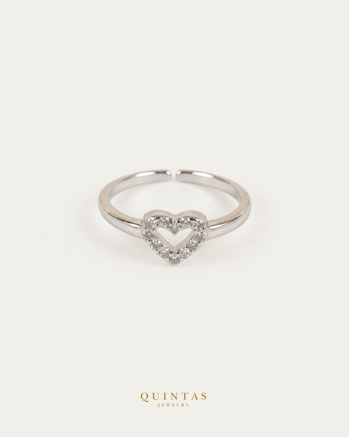 Amelia Heart Silver Ring (Adjustable) — authentic gold QUINTAS JEWELRY logo, standalone lying main, smaller centered framing