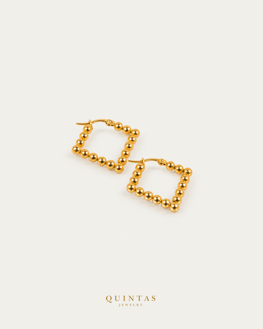 Golden Beaded Hoop Earrings — genuine open-lever hoop pair, source-backed main view, small balanced off-white composition and authentic canonical logo
