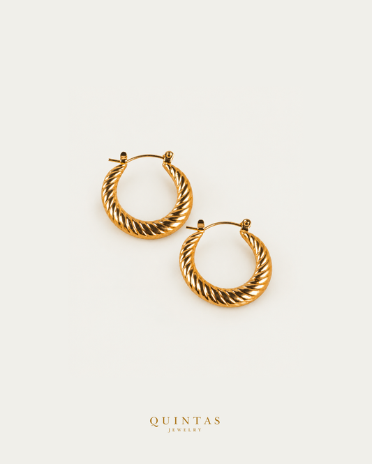 Solenne Twisted Hoop Earrings — genuine open-lever hoop pair, source-backed main view, small balanced off-white composition and authentic canonical logo
