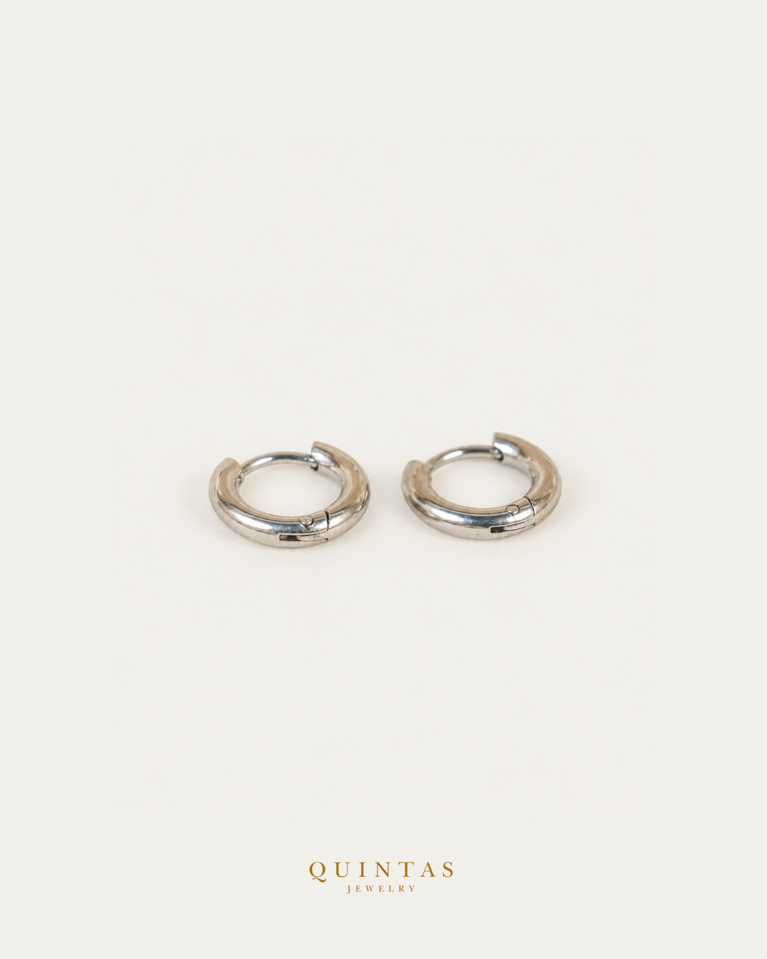 Classic Hoop Silver Earrings — source-backed complete hoop pair, source-backed main view, small balanced off-white composition and authentic canonical logo