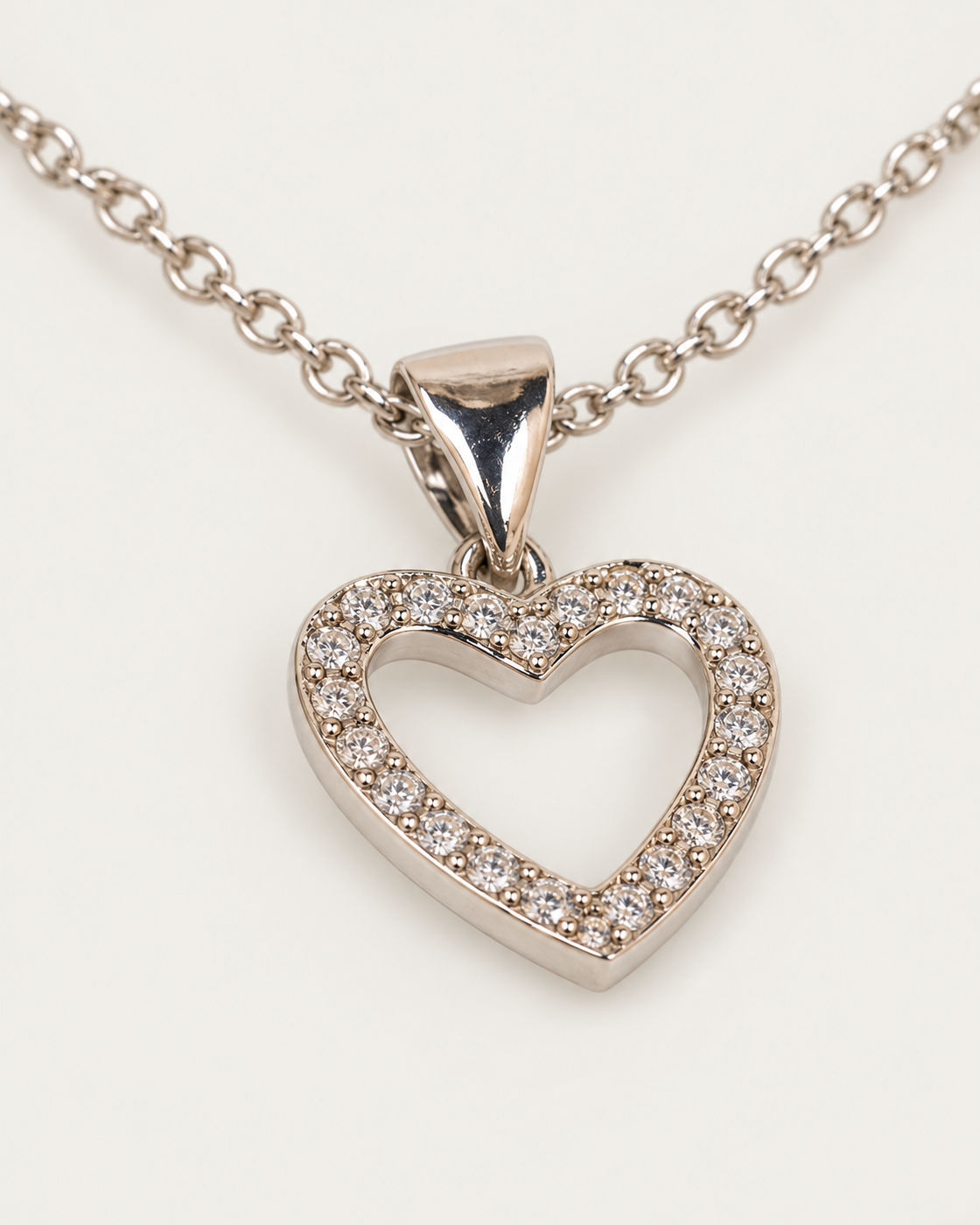 Arielle Silver Heart Necklace — cable chain, genuine oblique detail, neutral greige background
