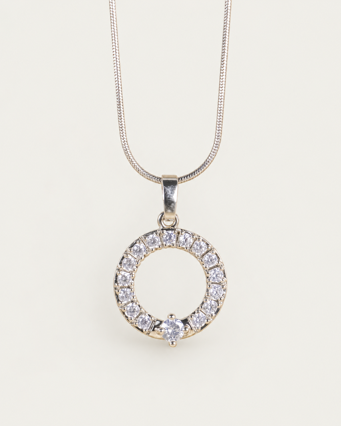 Crystal Orbit Silver Necklace — snake chain, front hero, neutral greige background