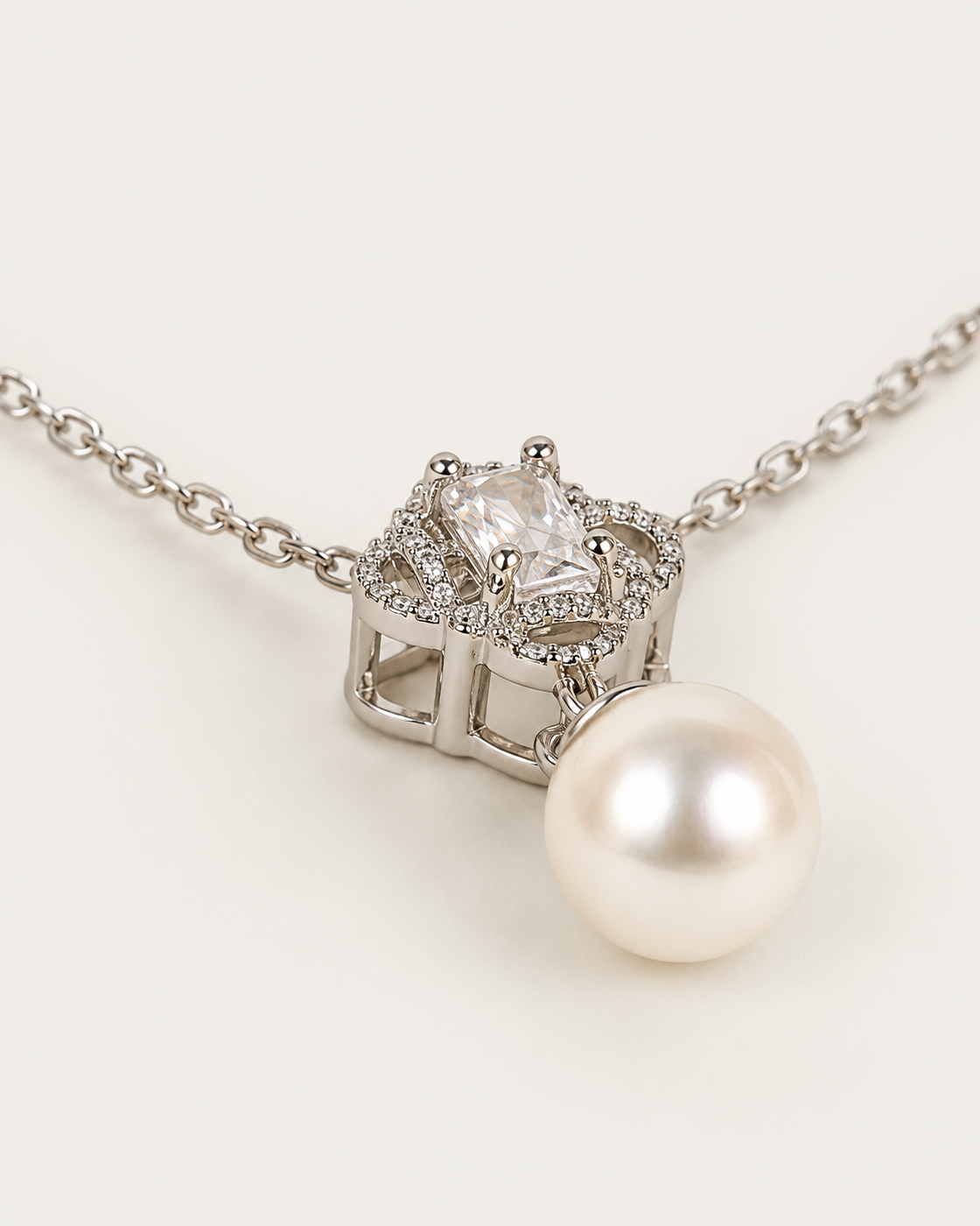 Margaux Pearl Drop Necklace — cable chain, genuine oblique detail, neutral greige background