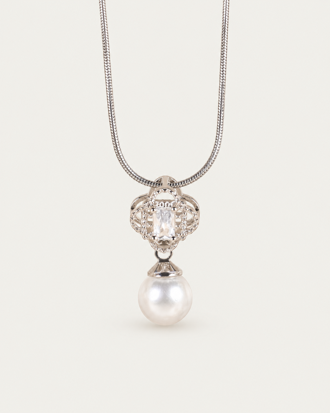 Margaux Pearl Drop Necklace — snake chain, front hero, neutral greige background