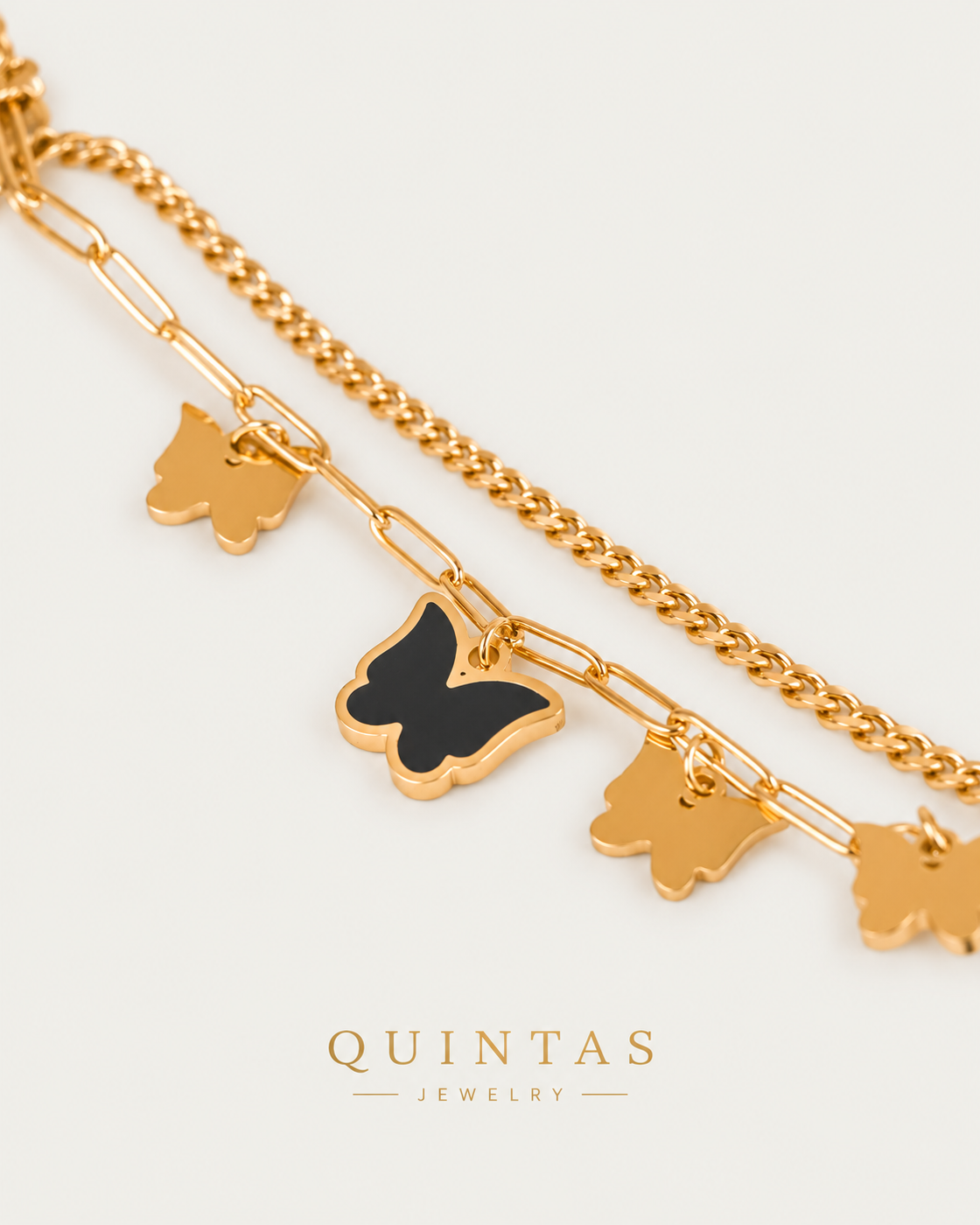 Midnight Butterfly Bracelet — gold bracelet, genuine oblique detail, neutral greige background