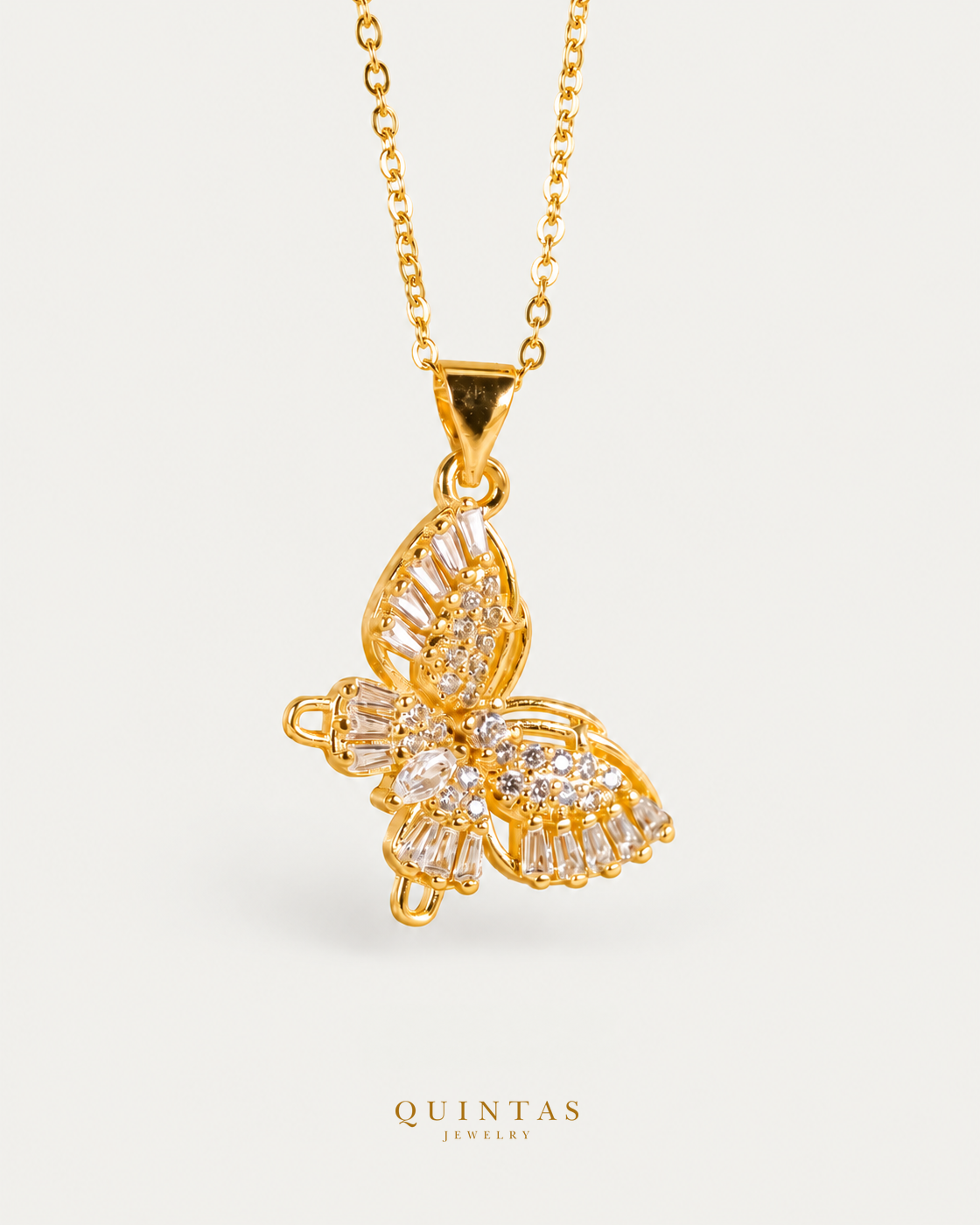 Celestis Butterfly Necklace on gold cable chain, hero angle, neutral greige