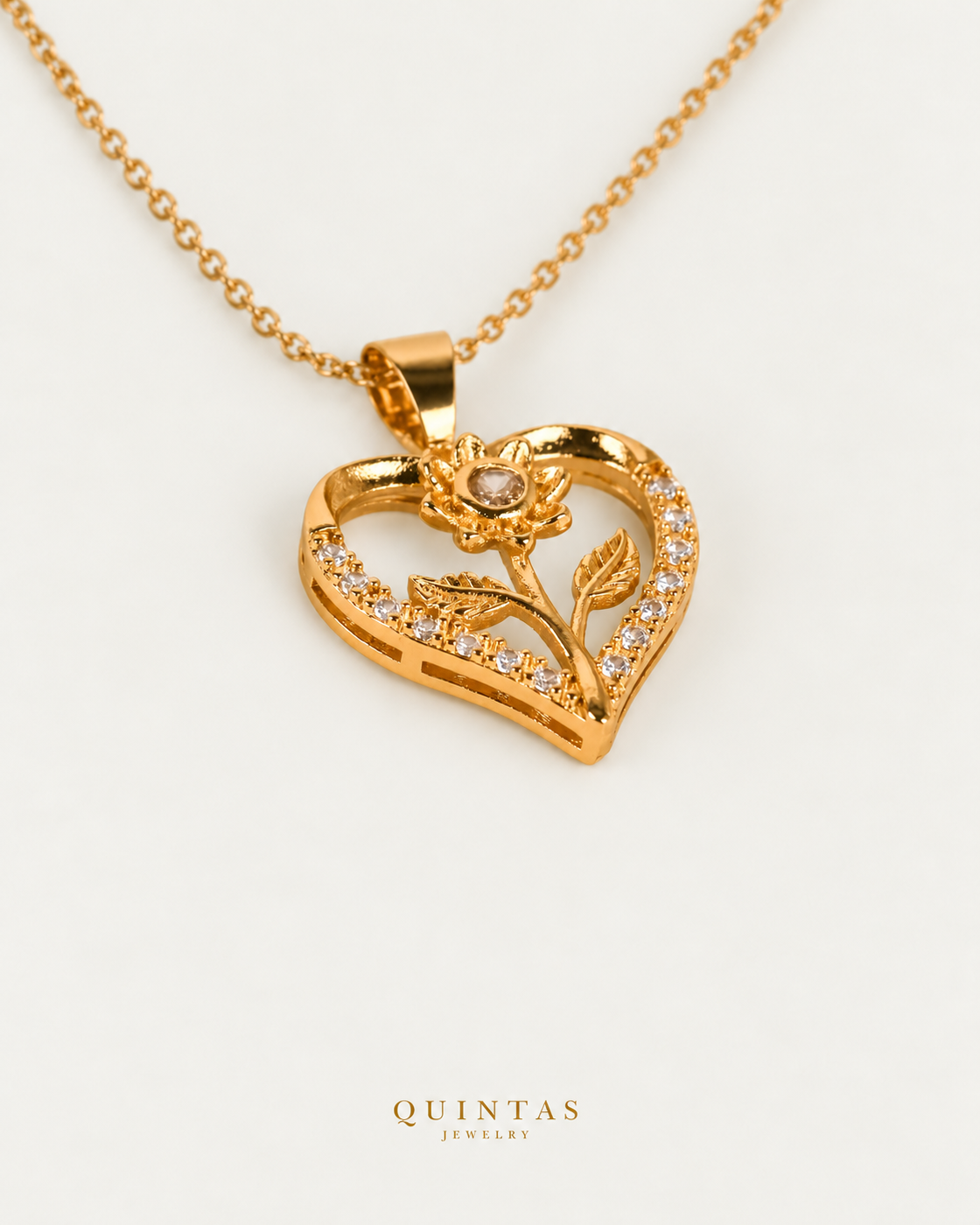 Flower Heart Charm Necklace on gold cable chain, companion angle, neutral greige