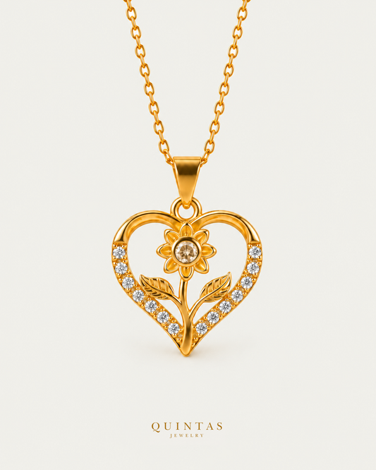 Flower Heart Charm Necklace on gold cable chain, hero angle, neutral greige