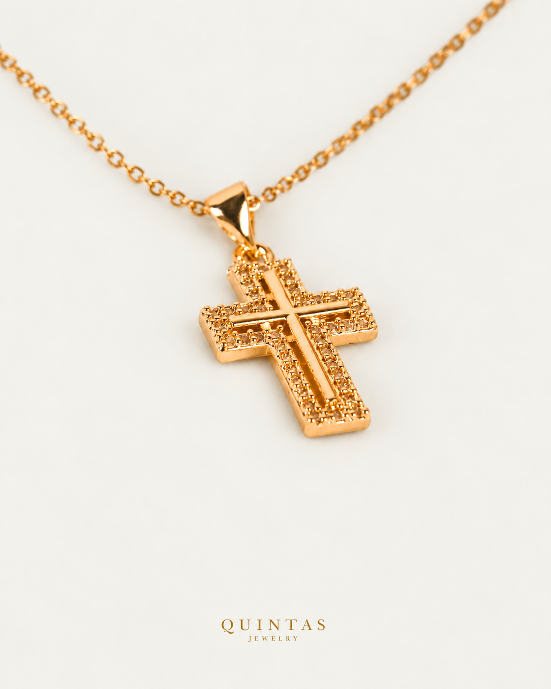 Graceful Cross Necklace — source-verified cable oblique view, off-white background, canonical gold logo