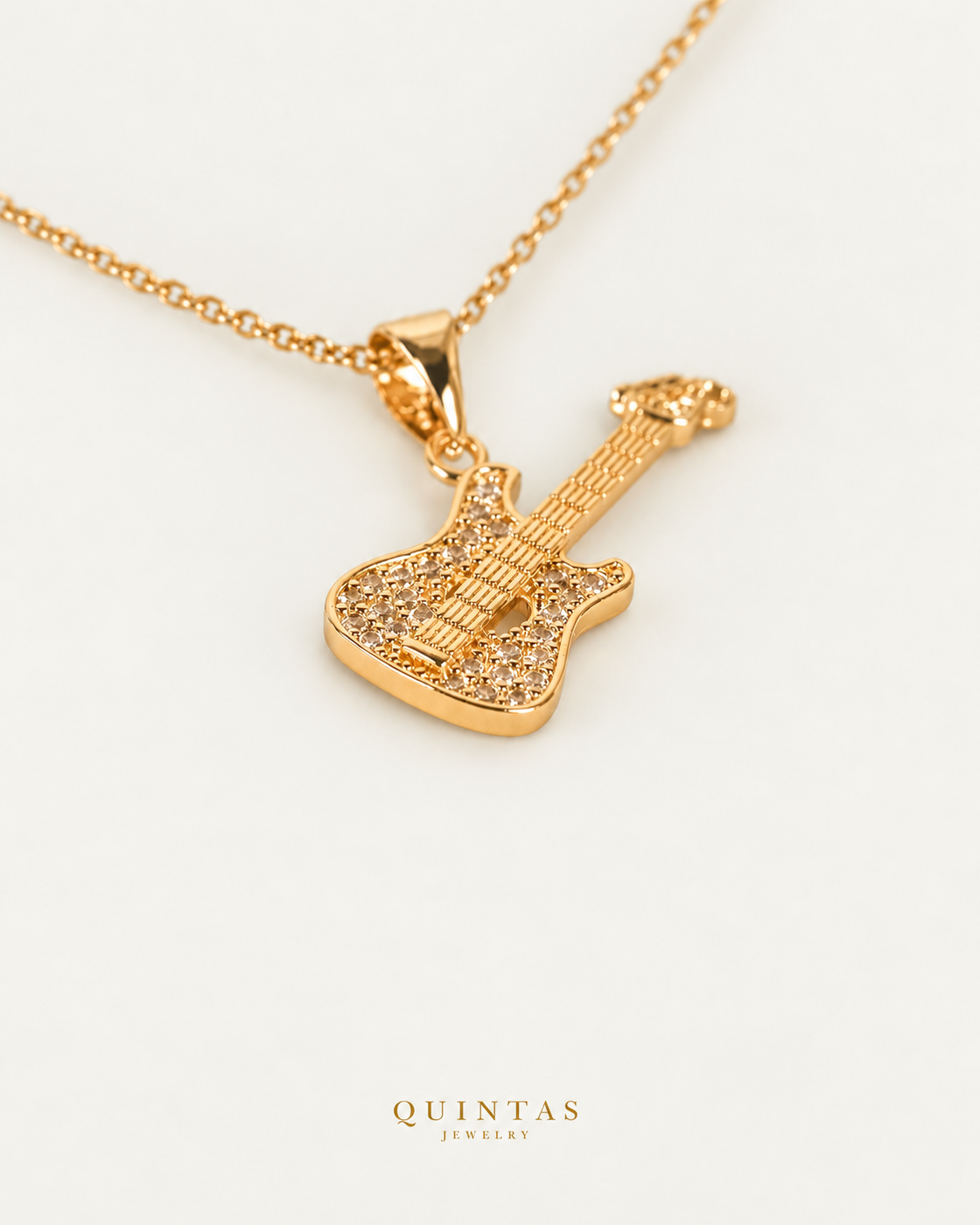 Guitar Charm Necklace — gold cable chain, companion view, canonical Quintas logo