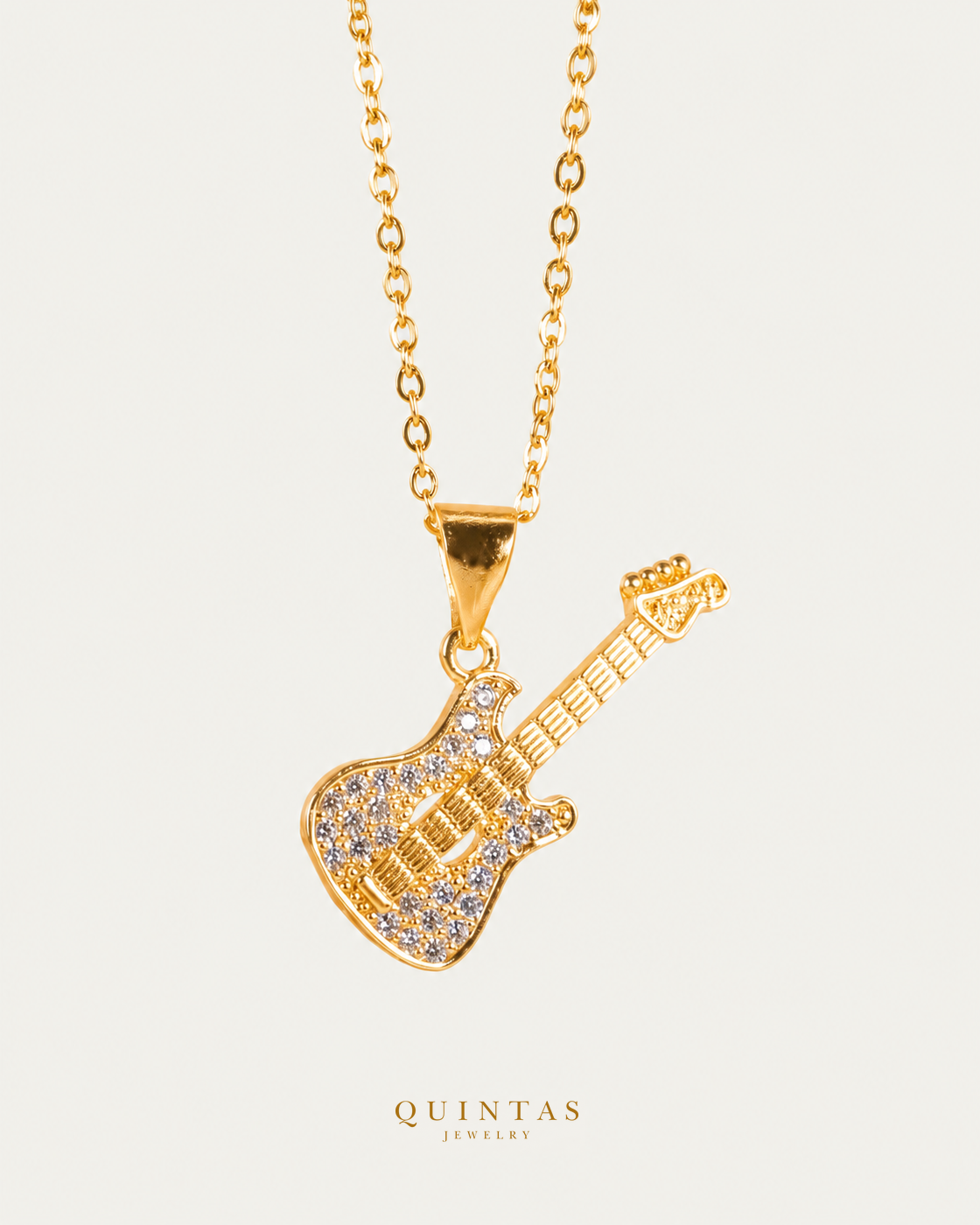 Guitar Charm Necklace — gold cable chain, hero view, canonical Quintas logo