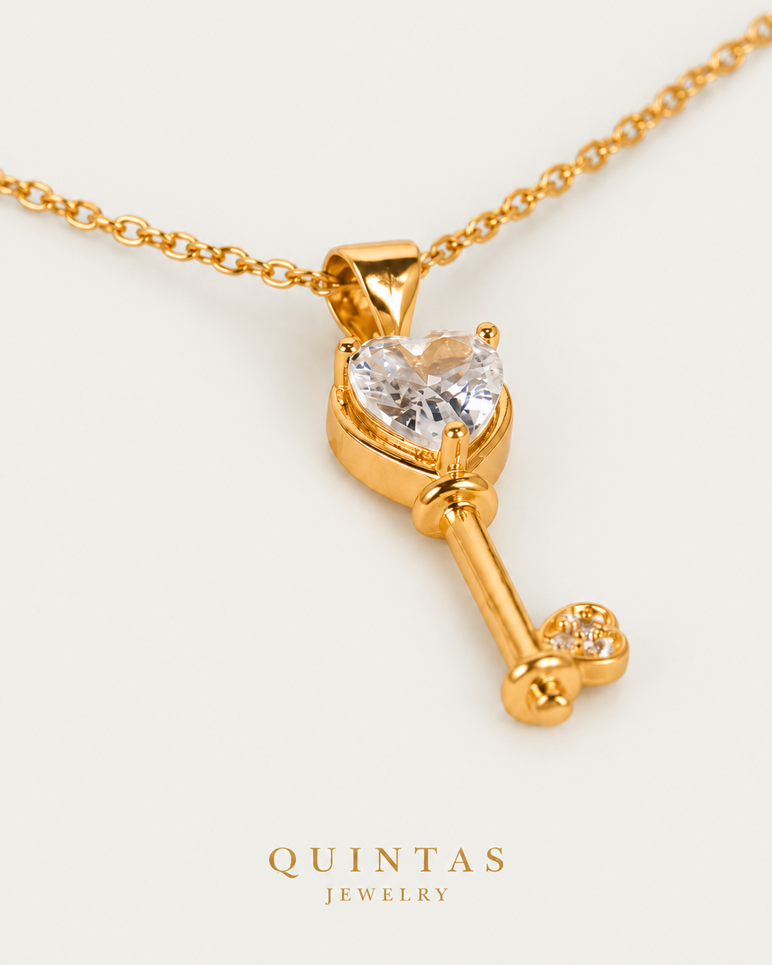 Key Diamond Heart Necklace, gold cable chain, oblique detail on neutral greige