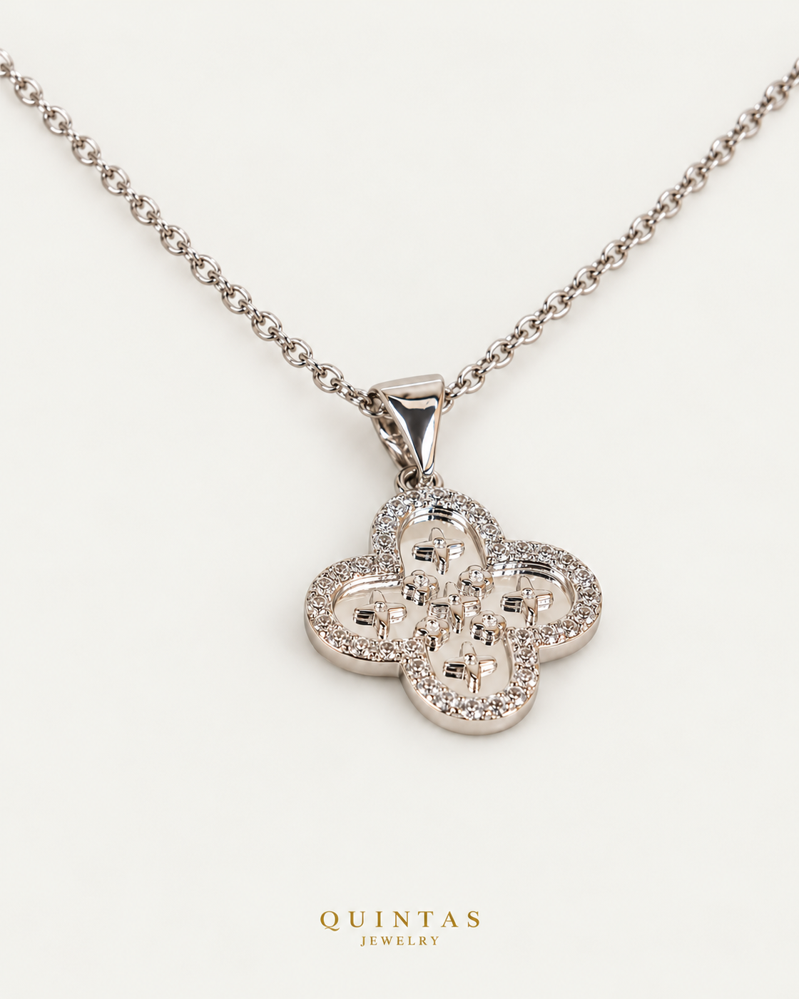 Silver Clover Charm Necklace cable chain companion angle on neutral greige