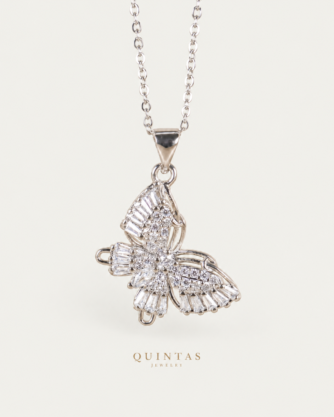 Celeste Butterfly Silver cable chain hero photographed angle on neutral greige