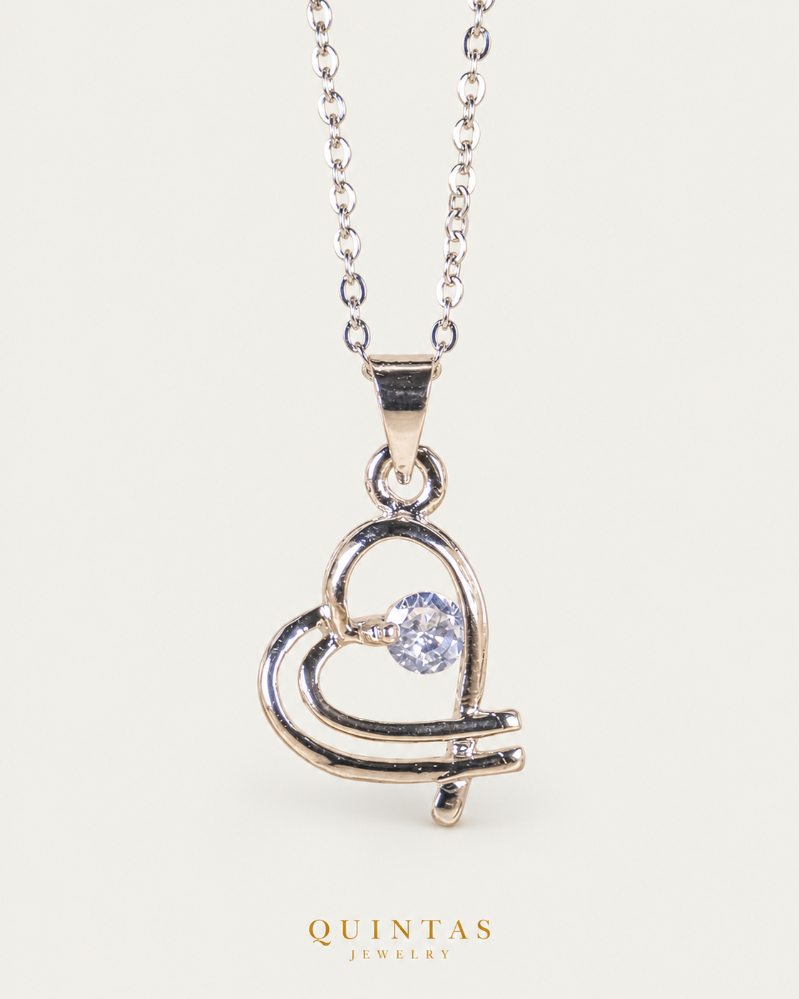 Interwined Hearts Silver Necklace cable chain hero angle on neutral greige