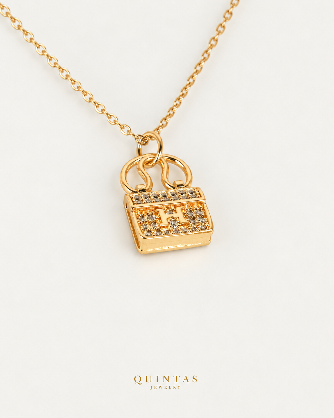 Mini Bag Necklace — gold cable chain, companion view, canonical Quintas logo