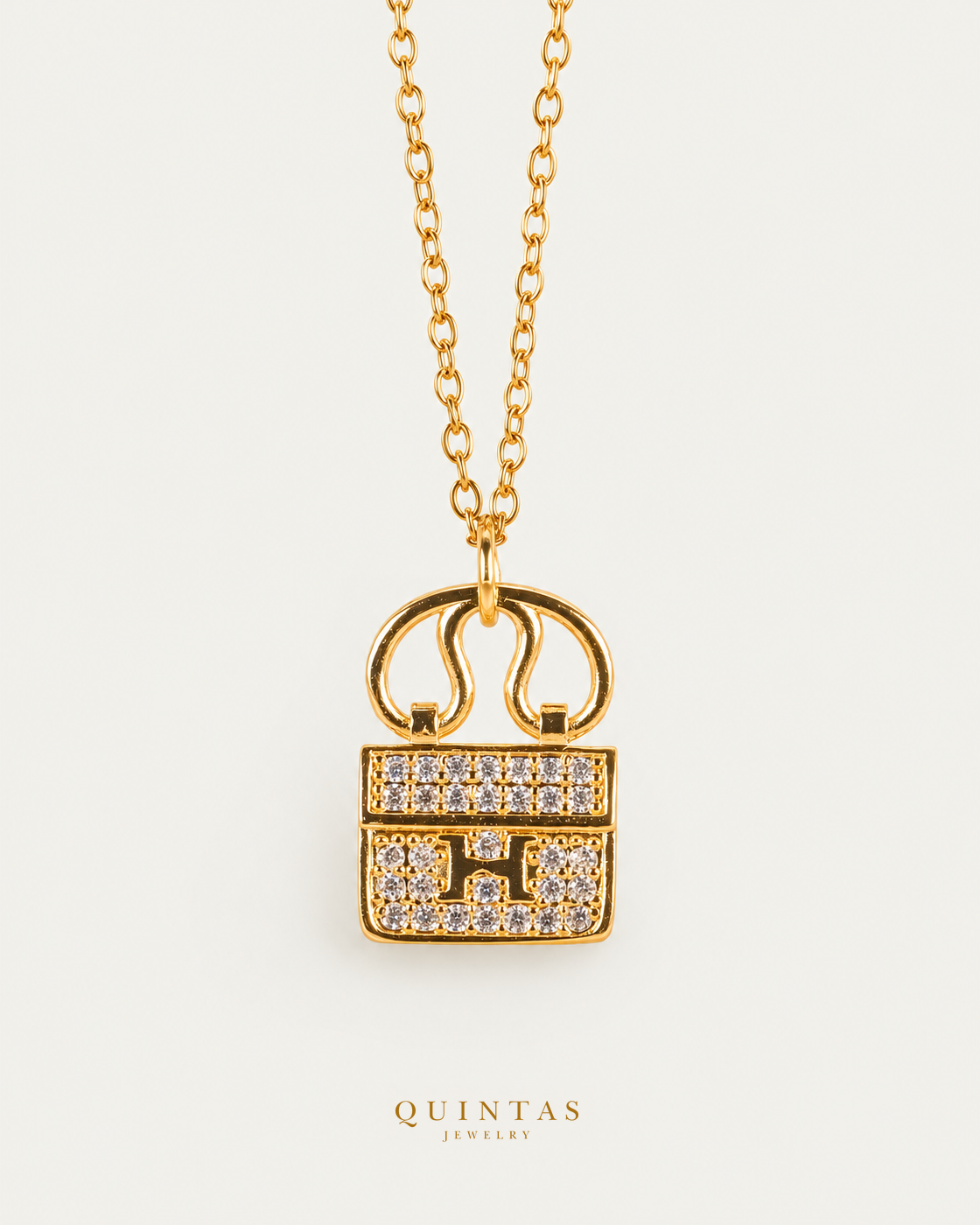 Mini Bag Necklace — gold cable chain, hero view, canonical Quintas logo