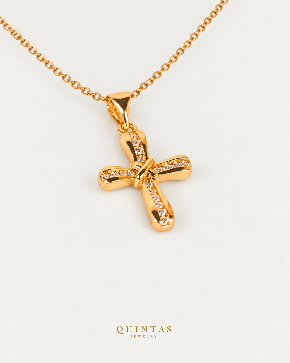 Knot Cross Necklace — source-verified cable oblique view, off-white background, canonical gold logo