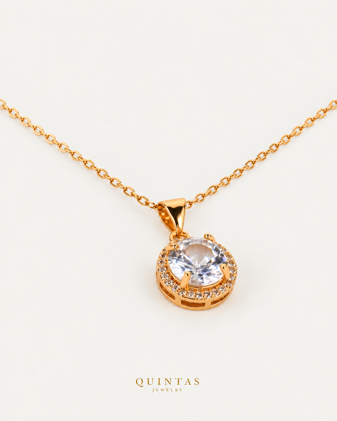 SolenneHalo necklace — actual cable-chain oblique view, neutral greige; canonical Quintas Jewelry logo