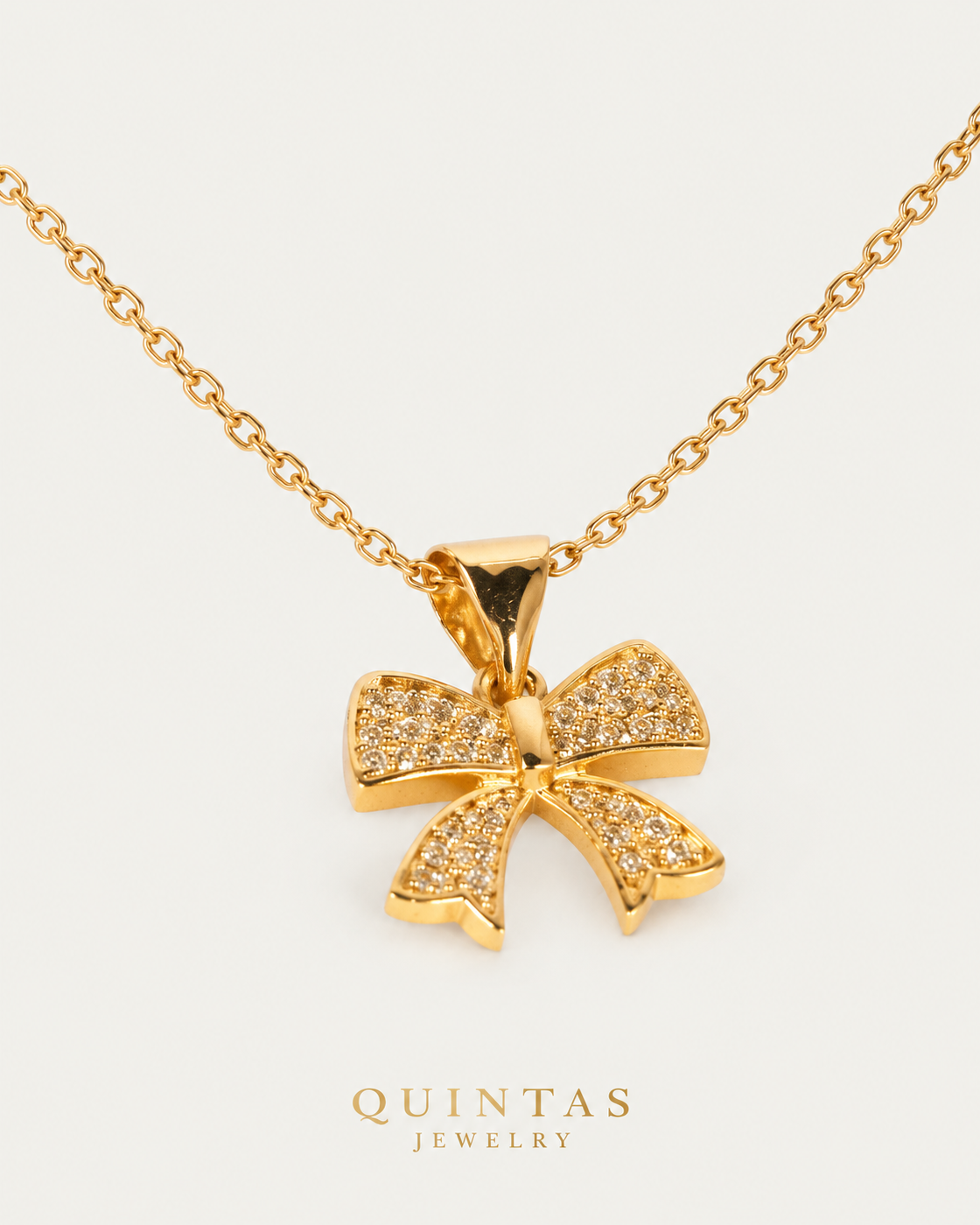 Velora Bow Necklace cable chain companion angle on neutral greige