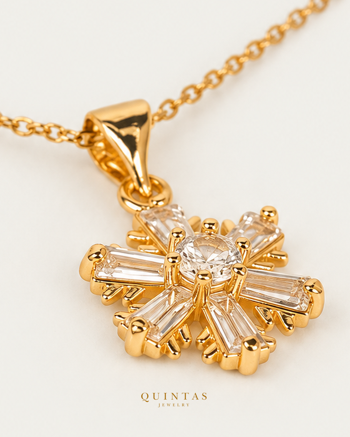 Iced Snowflake Necklace — source-verified cable oblique view, off-white background, canonical gold logo
