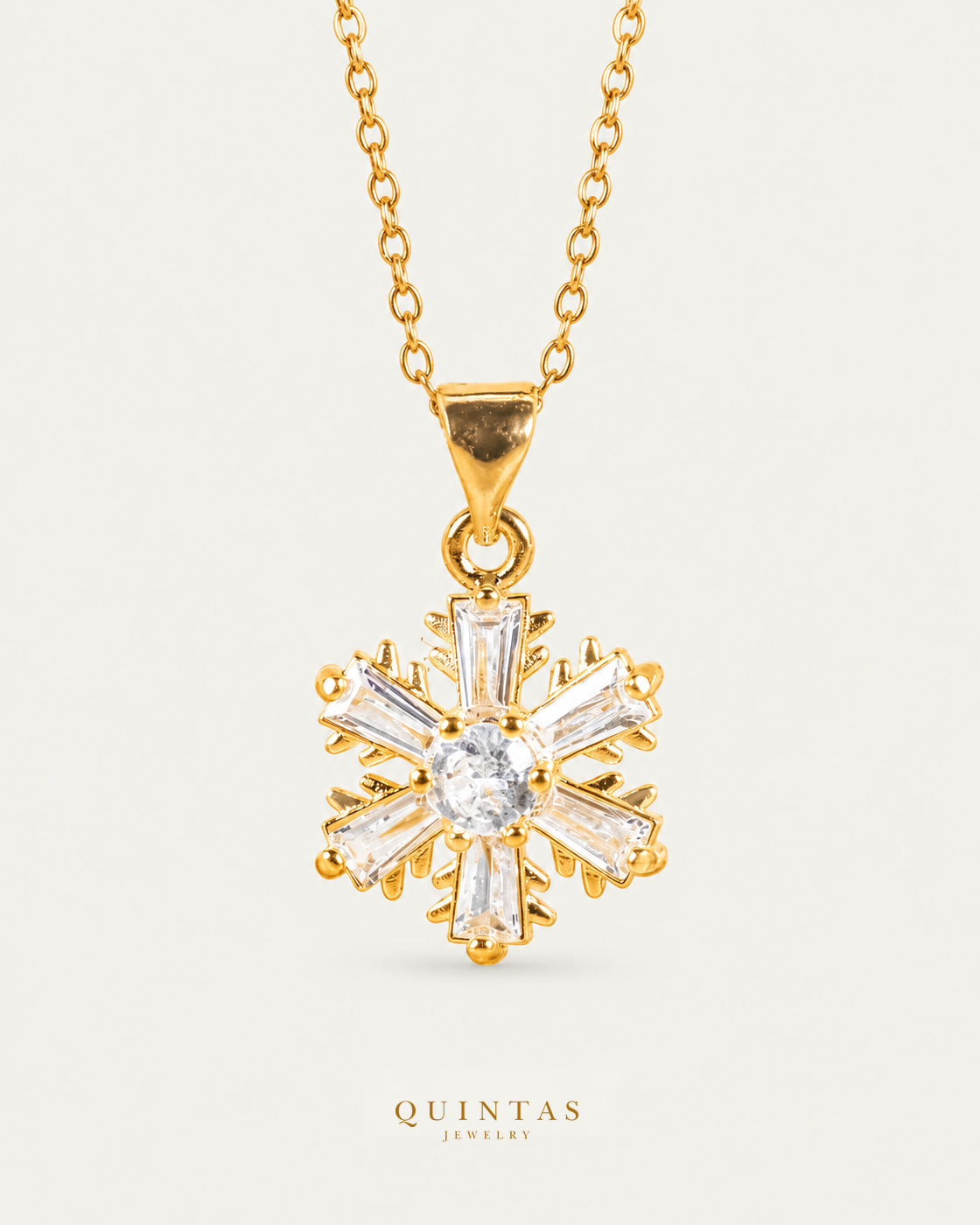 Iced Snowflake Necklace — source-verified cable front view, off-white background, canonical gold logo
