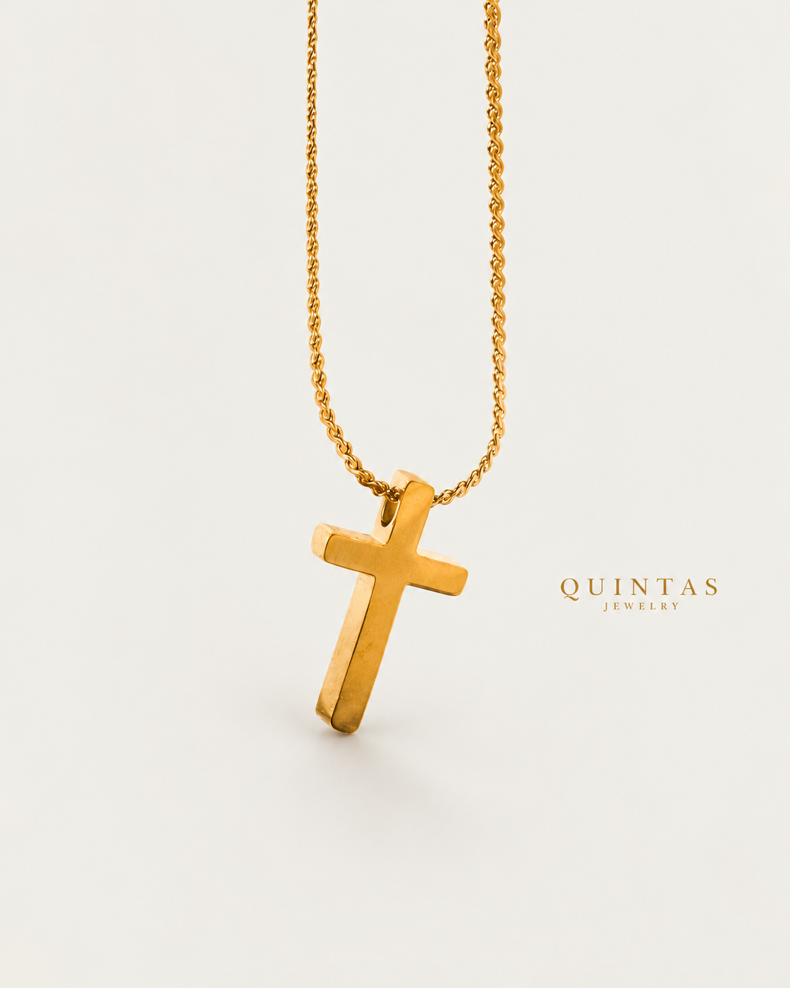 Mini Cross Necklace gold chain genuine reverse oblique angle on neutral greige