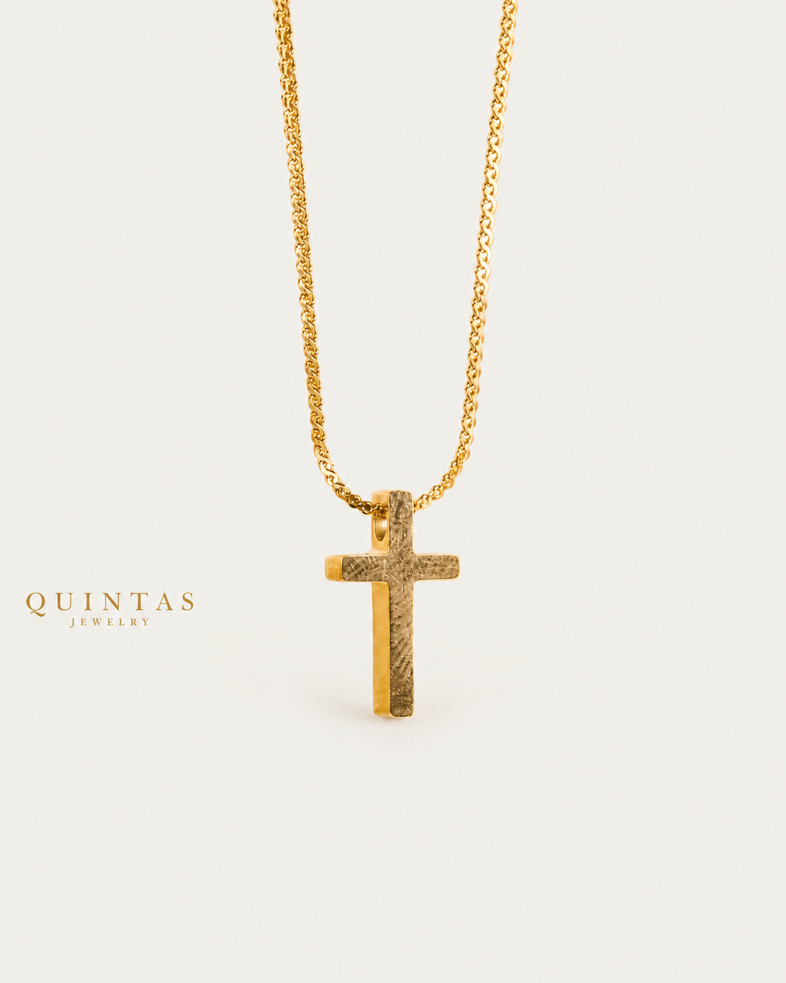 Mini Cross Necklace gold chain hero angle on neutral greige