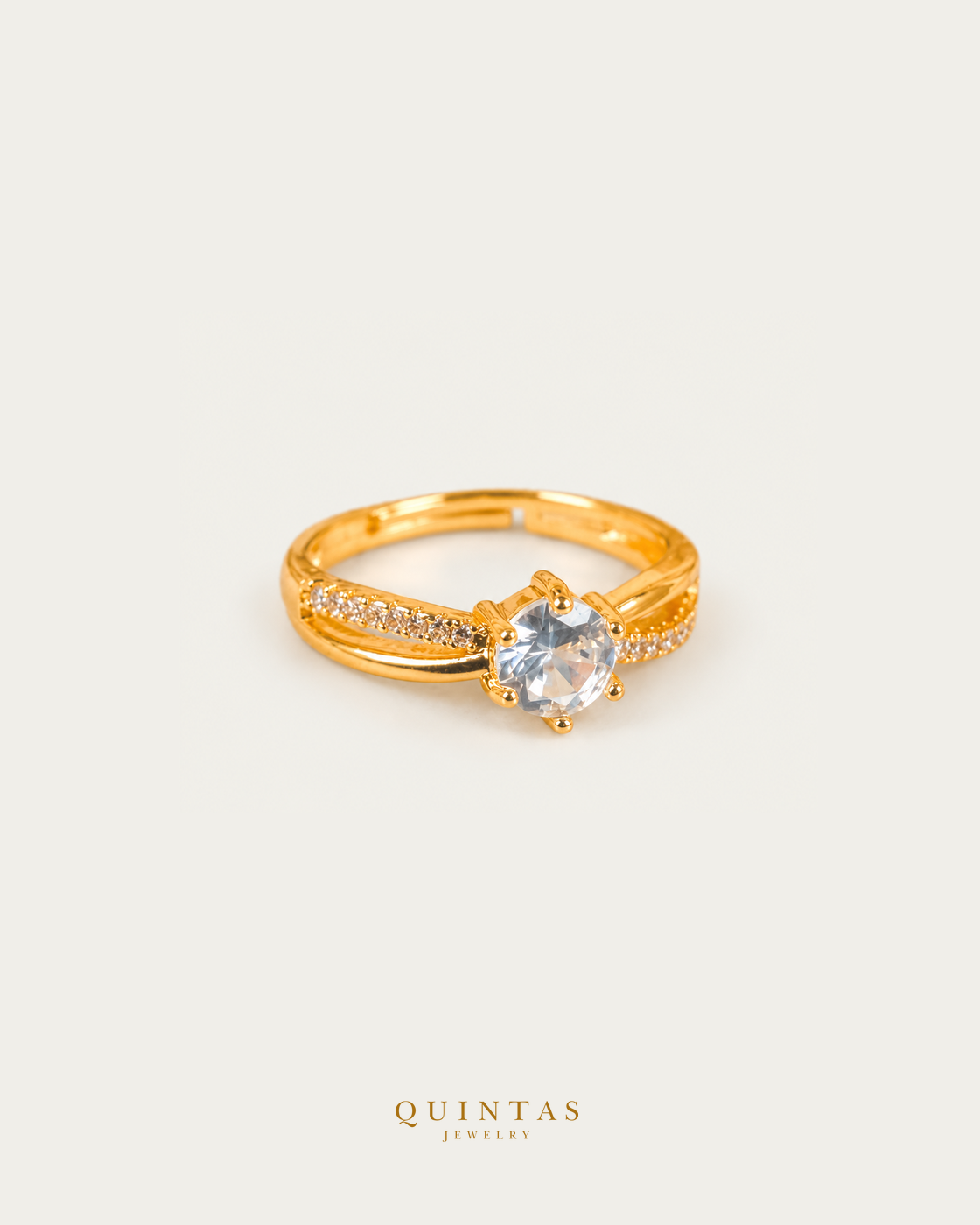 Celeste Solitaire Gold Ring (Adjustable), smaller standalone full ring view, neutral greige, authentic Quintas Jewelry gold logo