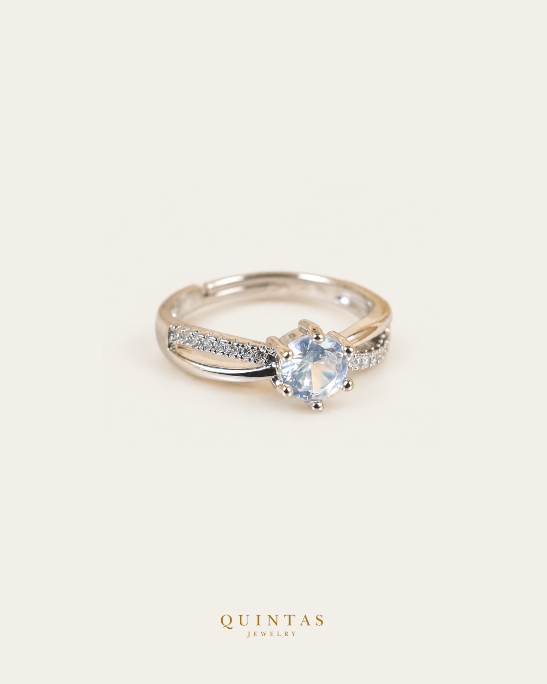 Celeste Solitaire Silver Ring (Adjustable), smaller standalone full ring view, neutral greige, authentic Quintas Jewelry gold logo