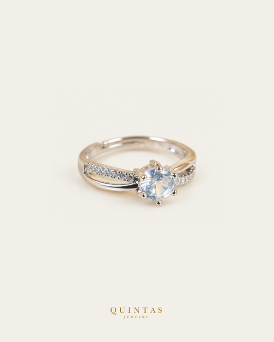 Celeste Solitaire Silver Ring (Adjustable), smaller standalone full ring view, neutral greige, authentic Quintas Jewelry gold logo