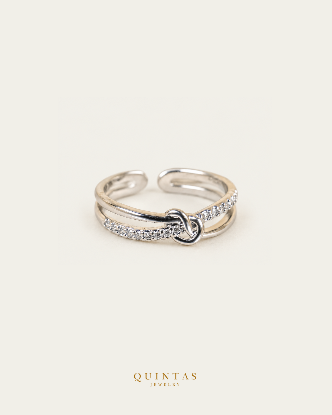 Liora Knot Silver Ring (Adjustable), smaller standalone full ring view, neutral greige, authentic Quintas Jewelry gold logo