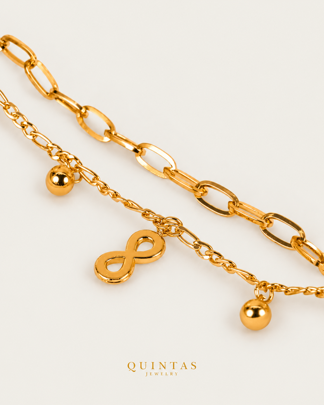 Infinity Layered Bracelet gold bracelet companion photographed angle on neutral greige