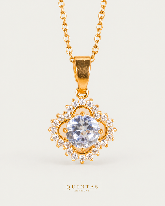 Adelia Bloom Necklace — source-verified cable front view, off-white background, canonical gold logo