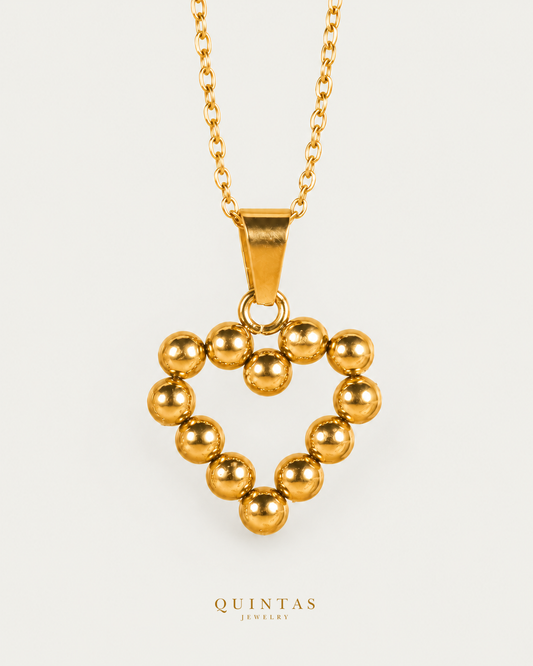 Ameline Beaded Heart Necklace on gold cable chain, hero angle, neutral greige