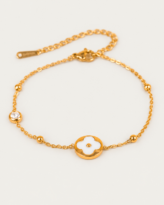 Camille Flower Charm WHITE actual gold bracelet hero photographed angle on neutral greige