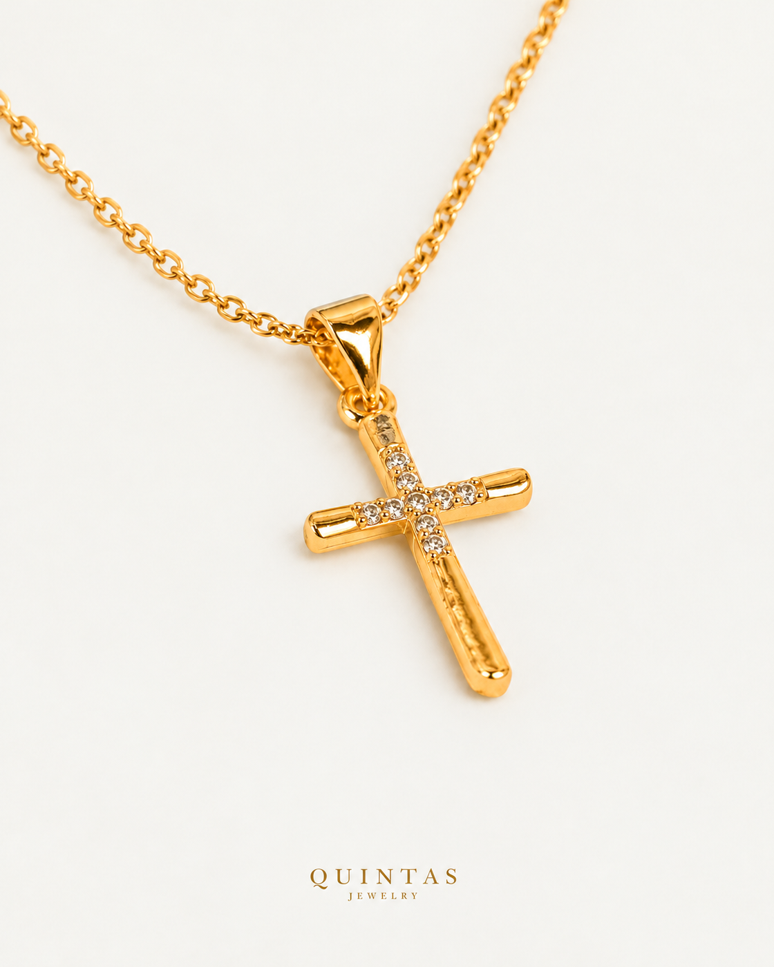 Studded Cross Necklace on gold cable chain, companion angle, neutral greige