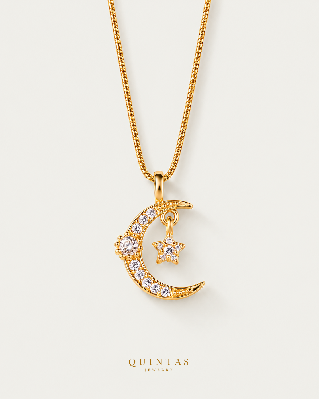 Luna Moon and Star Necklace — snake chain, neutral greige hero; canonical Quintas Jewelry logo
