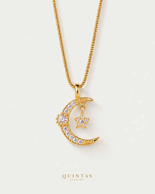 Luna Moon and Star Necklace — snake chain, neutral greige hero; canonical Quintas Jewelry logo