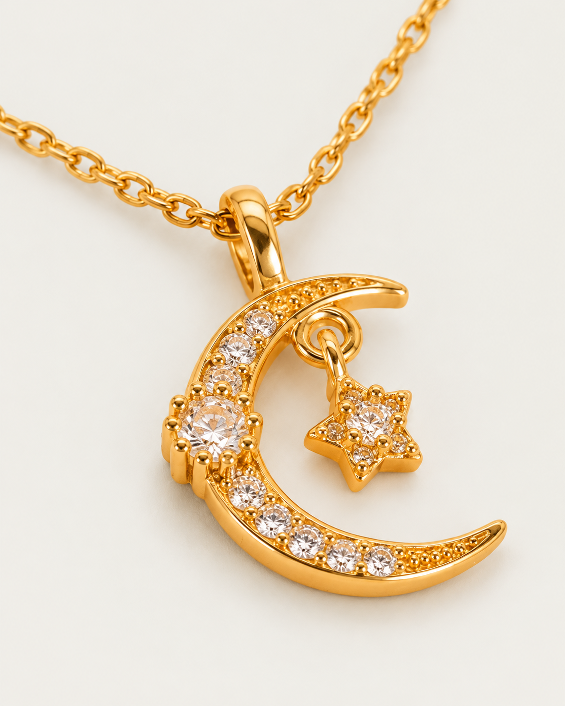 Luna Moon and Star Necklace cable chain companion photographed angle on neutral greige