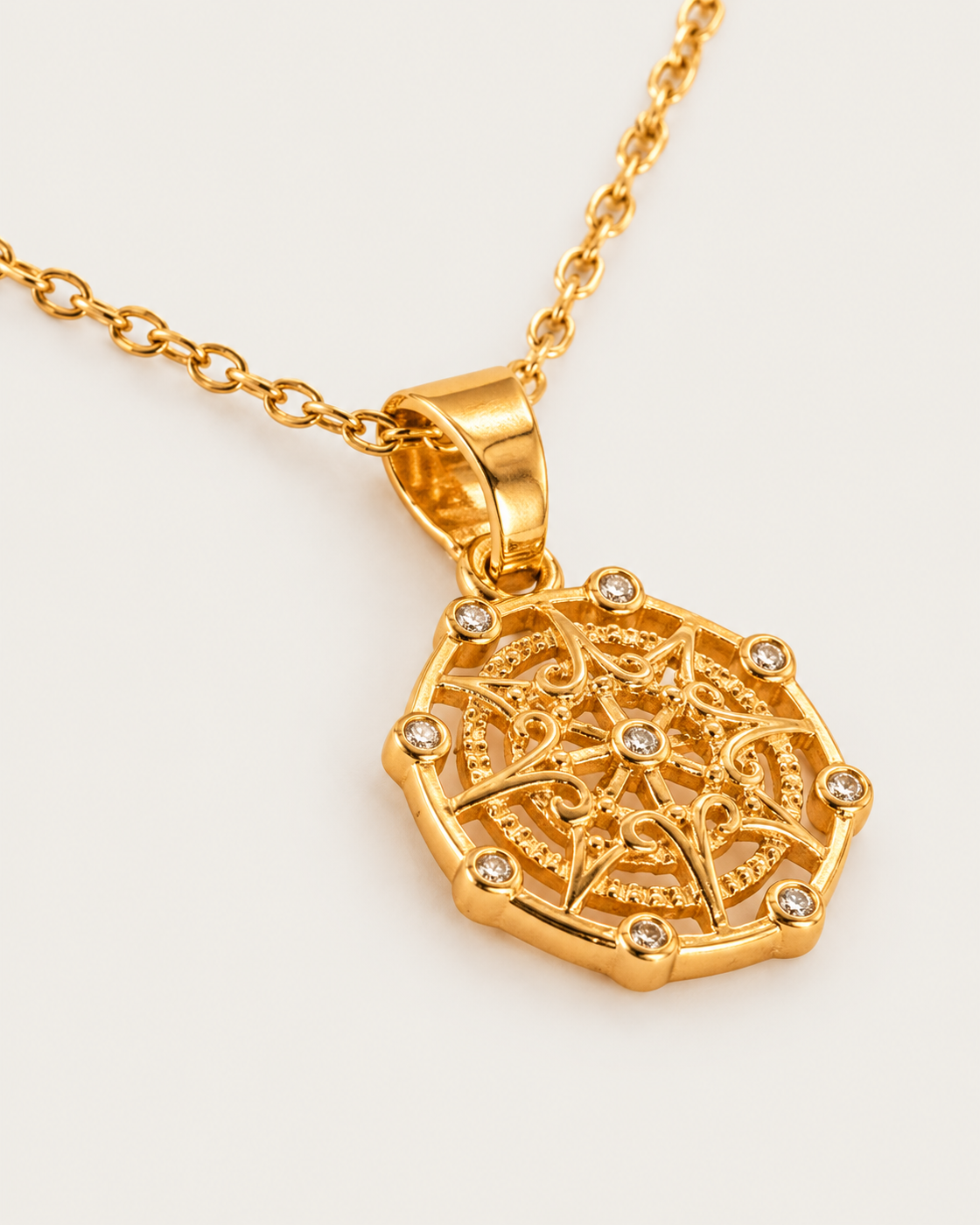 Amelia's Compass Necklace cable chain companion photographed angle on neutral greige