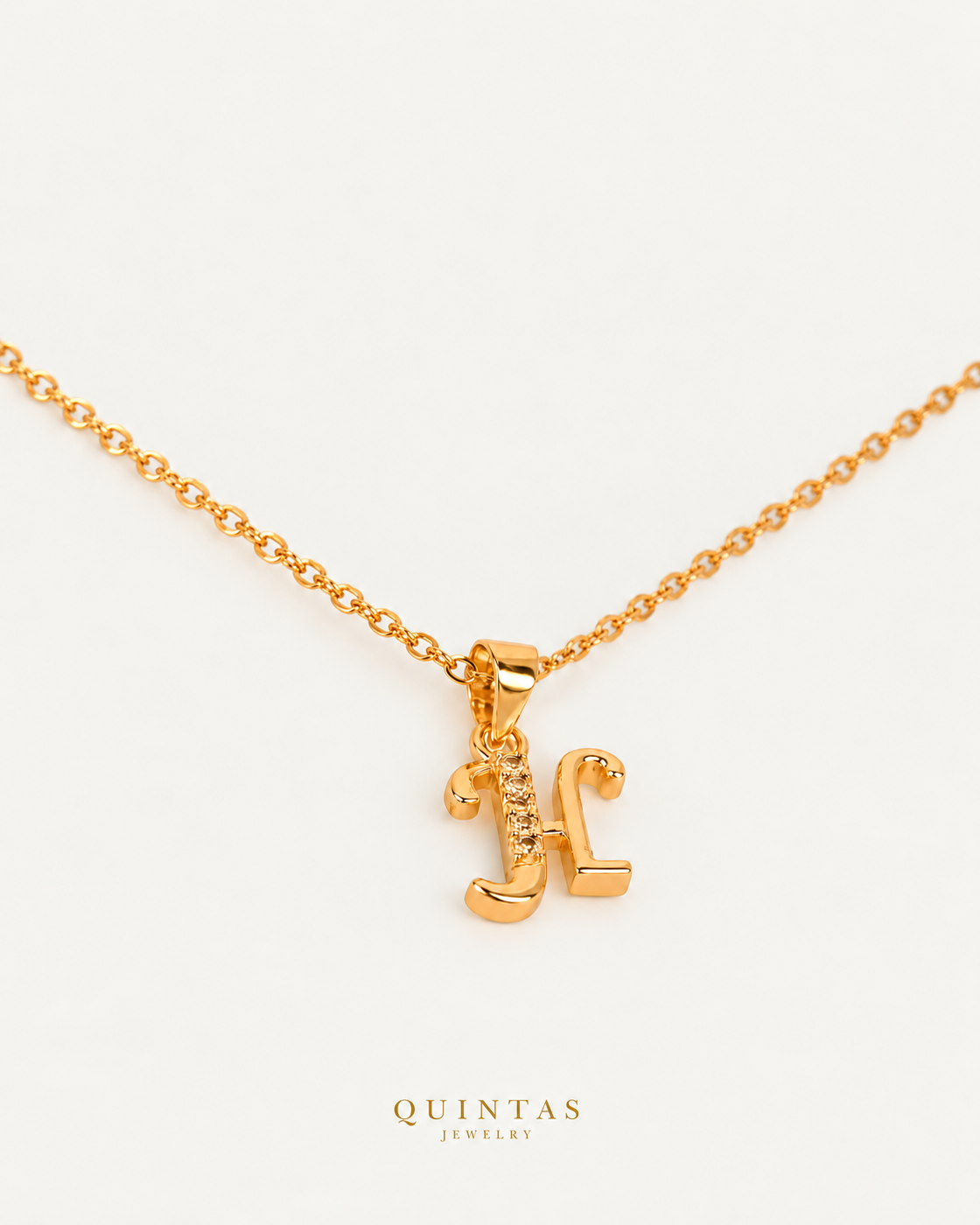 QUINTAS Letter Initial Necklace letter H on gold cable chain, companion angle, neutral greige