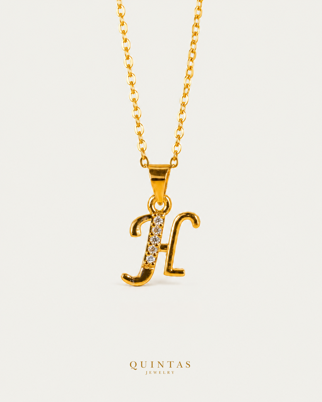 QUINTAS Letter Initial Necklace letter H on gold cable chain, hero angle, neutral greige