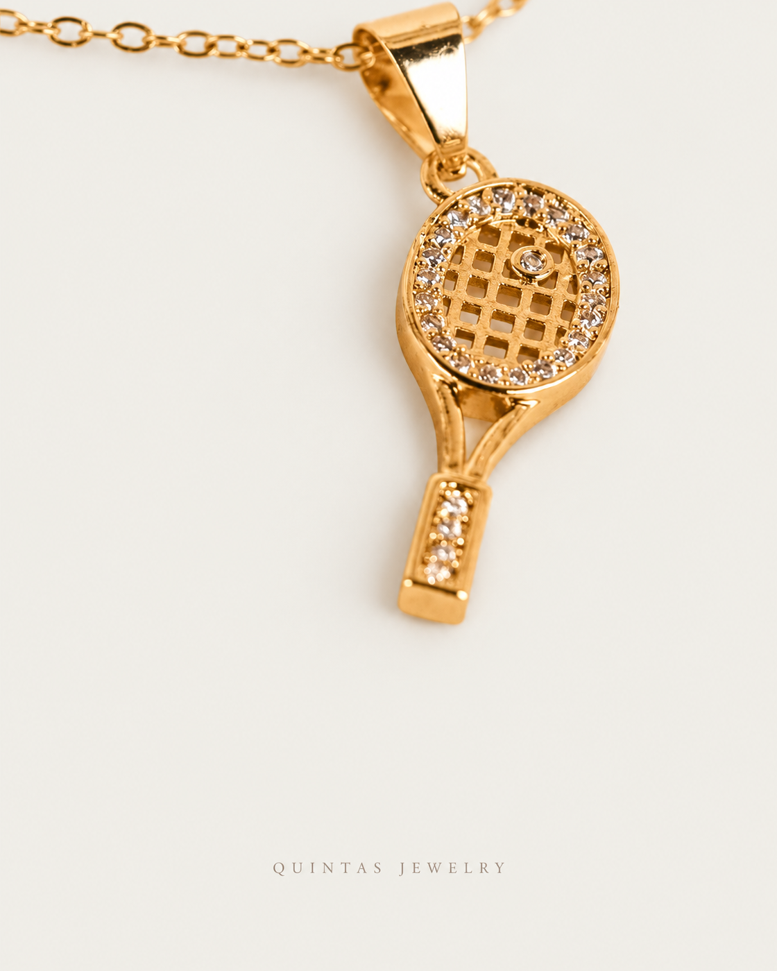 Golden Tennis Racket Necklace — gold cable chain, genuine oblique angle, neutral greige