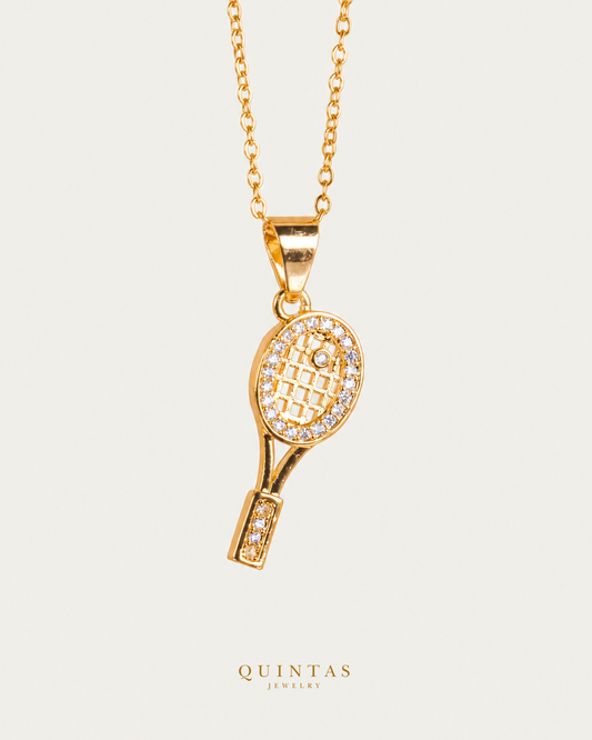 Golden Tennis Racket Necklace — gold cable chain, hero view, canonical Quintas logo