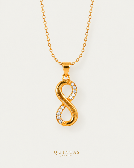 Infinity Necklace — cable chain, neutral greige hero; canonical Quintas Jewelry logo