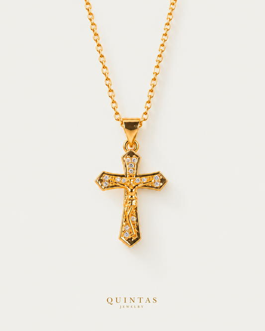 Christian's Rhinestone Cross Necklace — cable chain, neutral greige hero; canonical Quintas Jewelry logo