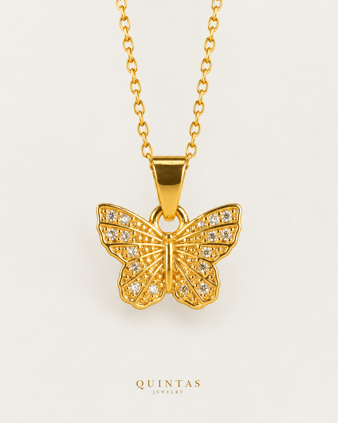 Caroline Butterfly Necklace — source-verified cable front view, off-white background, canonical gold logo