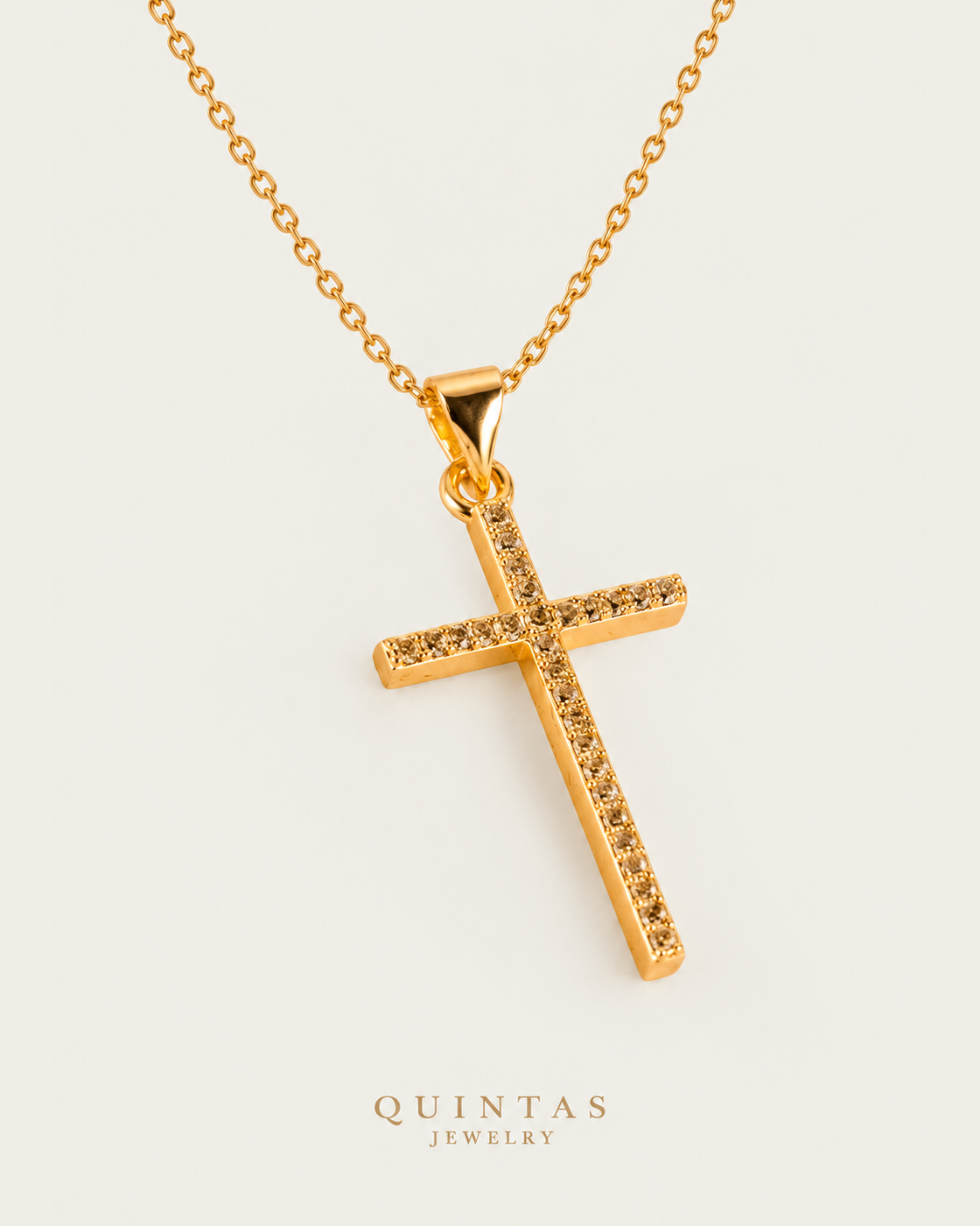Miracle Cross Necklace cable chain companion photographed angle on neutral greige