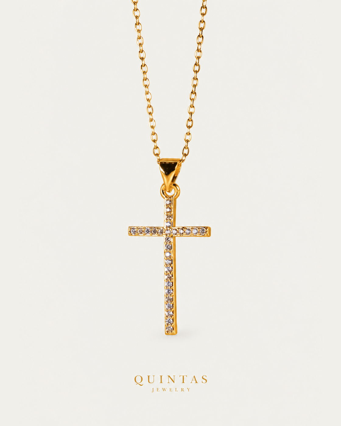Miracle Cross Necklace cable chain hero photographed angle on neutral greige